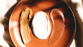 Balm, cream and ointment textures side by side on a ceramic plate